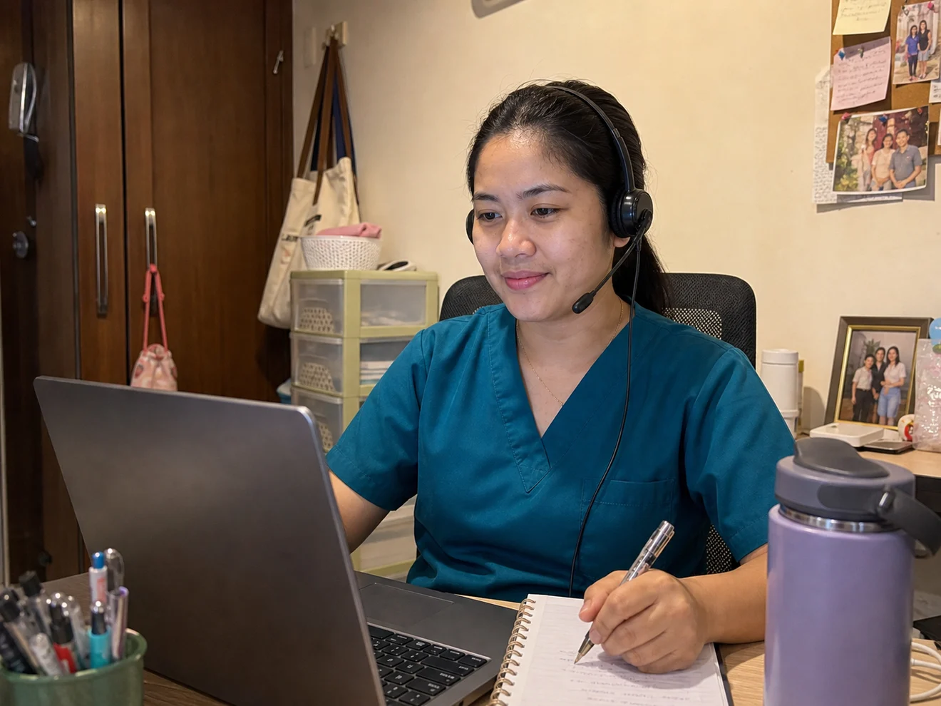 Filipino registered nurse virtual assistant working from a compact home workspace while supporting medical practice admin workflows.